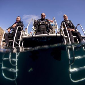 Adaptive diver Brian Anderson on the back of a boat